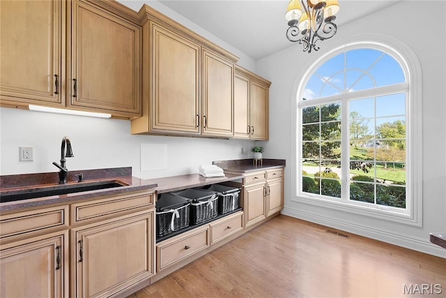 1 Claychester Dr, Saint Louis, MO 63131 - kitchen featuring a sink, plenty of natural light, light wood-style floors, and a chandelier