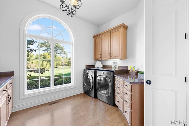 1 Claychester Dr, Saint Louis, MO 63131 - laundry area featuring cabinet space, washing machine and dryer, baseboards, light wood-style flooring, and a chandelier