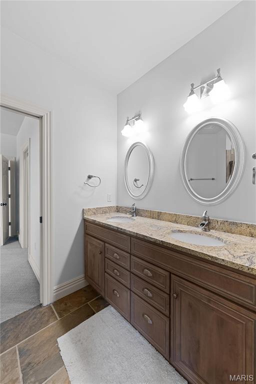 1 Claychester Dr, Saint Louis, MO 63131 - full bathroom with double vanity and baseboards