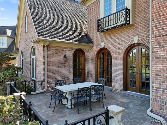 1 Claychester Dr, Saint Louis, MO 63131 - view of patio with french doors, outdoor dining area, and a balcony