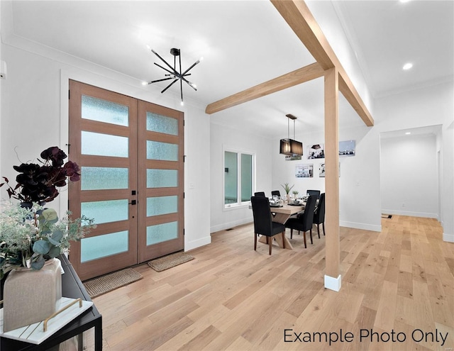 foyer with a chandelier, light wood-type flooring, baseboards, recessed lighting, and crown molding