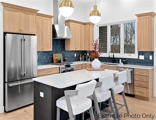 kitchen featuring stainless steel appliances, a sink, light brown cabinets, and light countertops