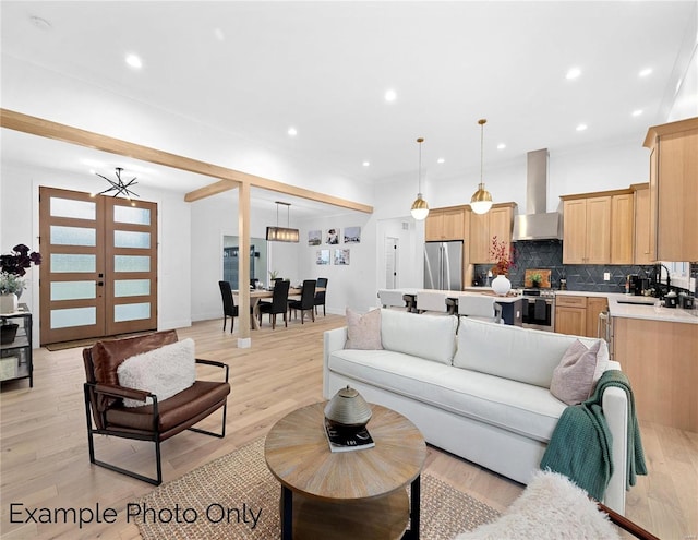 living area with light wood finished floors and recessed lighting