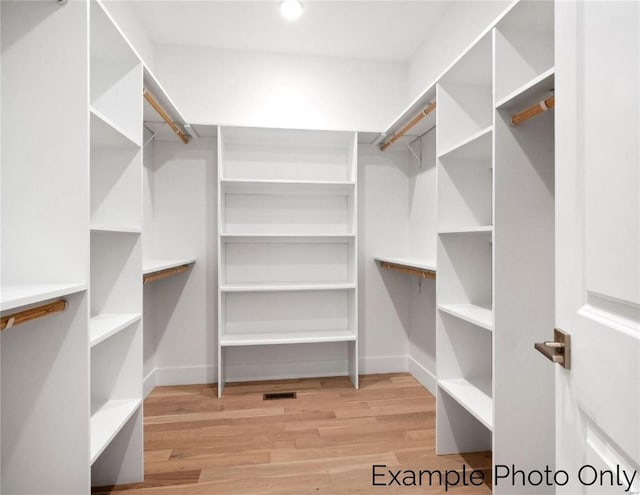 walk in closet featuring wood finished floors