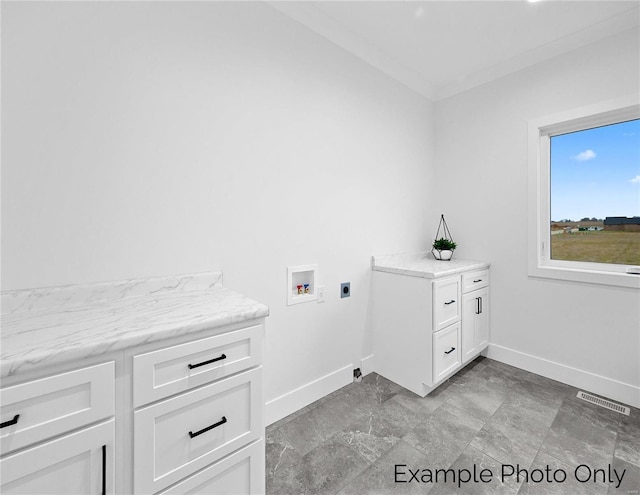 laundry area featuring baseboards, hookup for a washing machine, cabinet space, and electric dryer hookup