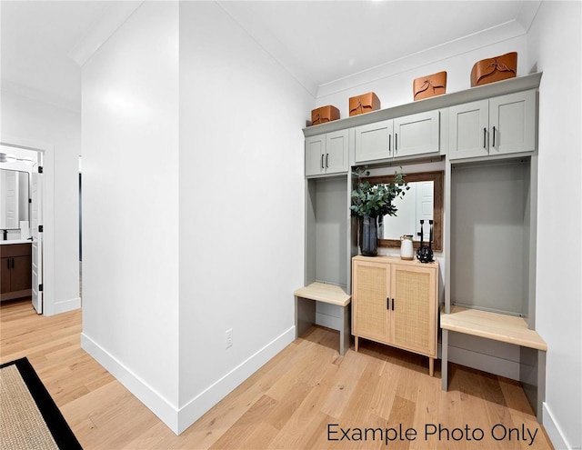 mudroom with crown molding, light wood finished floors, and baseboards