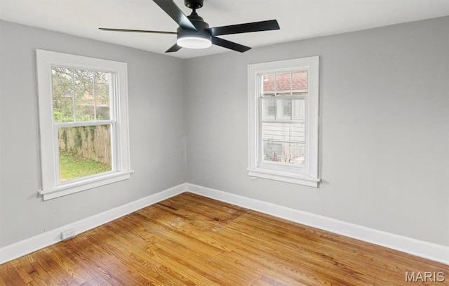 unfurnished room with baseboards, wood finished floors, and ceiling fan