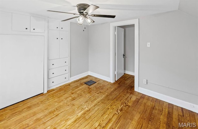 unfurnished bedroom with light wood finished floors, baseboards, ceiling fan, and a closet
