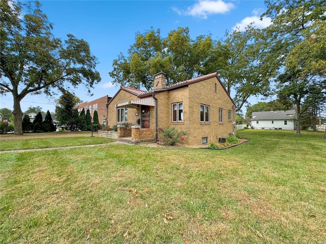 13 N Jackson St, Millstadt, IL 62260 - view of front facade featuring brick siding, a front lawn, and a chimney