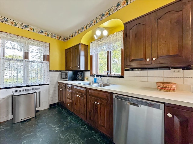 13 N Jackson St, Millstadt, IL 62260 - kitchen featuring appliances with stainless steel finishes, a sink, light countertops, concrete flooring, and tile walls