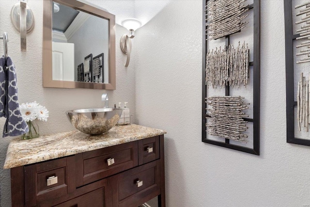 bathroom with crown molding and vanity