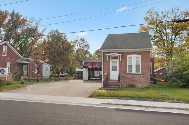 1826 Raab Ave, Belleville, IL 62226 - view of front facade featuring brick siding, a shingled roof, and a front yard