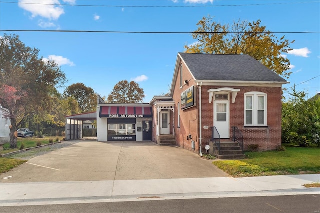 1826 Raab Ave, Belleville, IL 62226 - view of property featuring entry steps, brick siding, an attached carport, concrete driveway, and a shingled roof