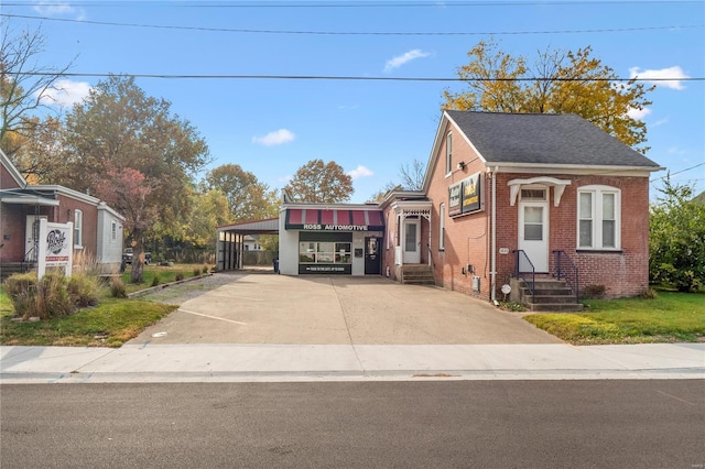 1826 Raab Ave, Belleville, IL 62226 - view of front of home featuring entry steps, brick siding, concrete driveway, a carport, and roof with shingles