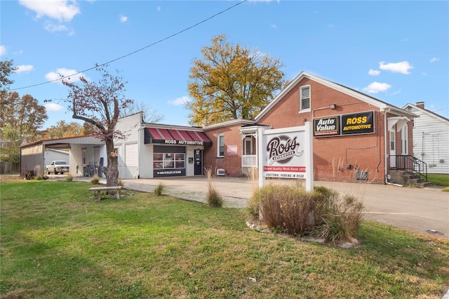 1826 Raab Ave, Belleville, IL 62226 - view of front facade featuring driveway, a front lawn, and a carport