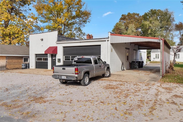 1826 Raab Ave, Belleville, IL 62226 - view of front facade with a chimney, a detached garage, and concrete block siding