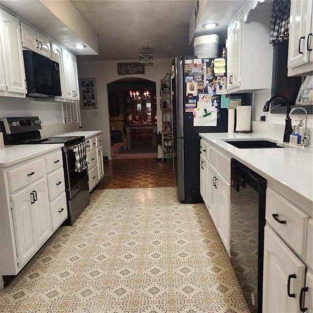 660 W 3rd, Trenton, IL 62293 - kitchen with black appliances, a sink, light countertops, and white cabinets