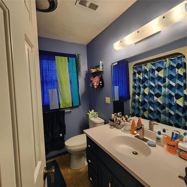 660 W 3rd, Trenton, IL 62293 - full bathroom with toilet, vanity, a textured wall, and a shower with shower curtain