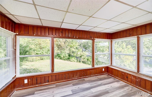 509 Royal Ave, Ferguson, MO 63135 - unfurnished sunroom featuring wooden walls, wood finished floors, plenty of natural light, and a drop ceiling