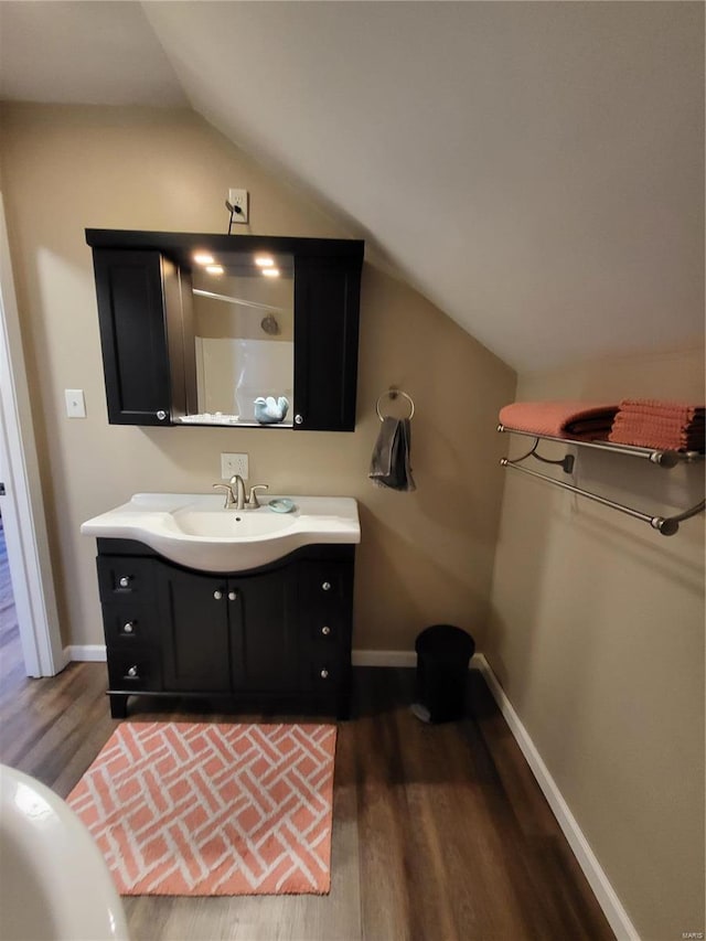 2724 Wayne Rte # Oo, Greenville, MO 63944 - bathroom featuring wood finished floors, vaulted ceiling, vanity, and baseboards