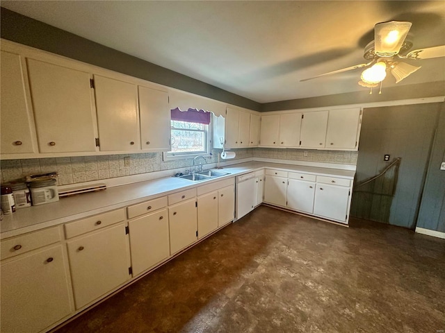 kitchen featuring a sink, decorative backsplash, white dishwasher, and light countertops