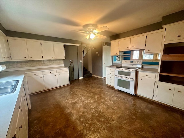 kitchen featuring range with two ovens, a ceiling fan, white cabinetry, dark floors, and a sink