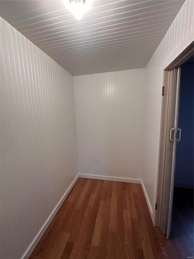 hall featuring wood finished floors and baseboards