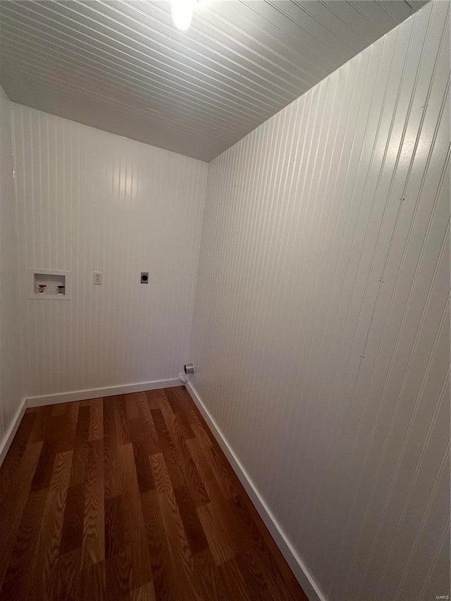 clothes washing area featuring electric dryer hookup, hookup for a washing machine, wood finished floors, and baseboards