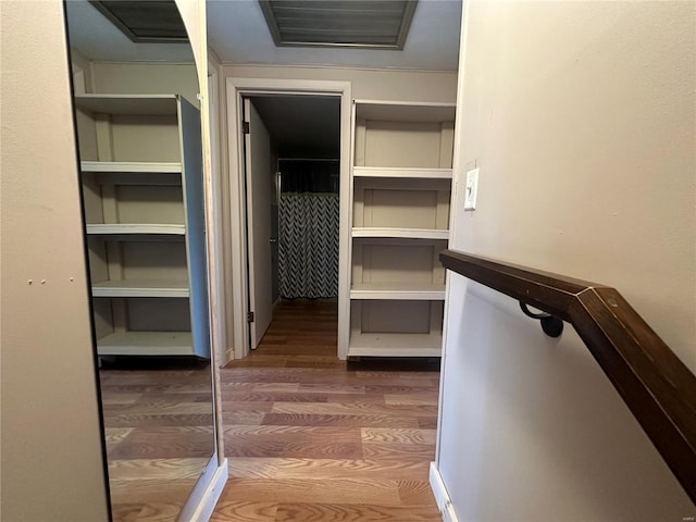 walk in closet featuring dark wood-style flooring