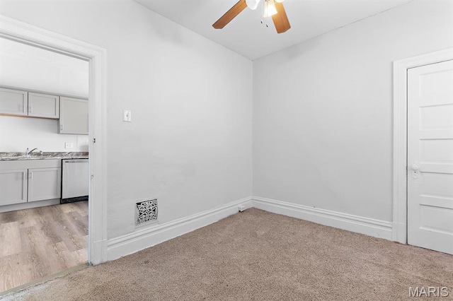3921 Shenandoah Ave, Saint Louis, MO 63110 - unfurnished room with light colored carpet, ceiling fan, a sink, and baseboards