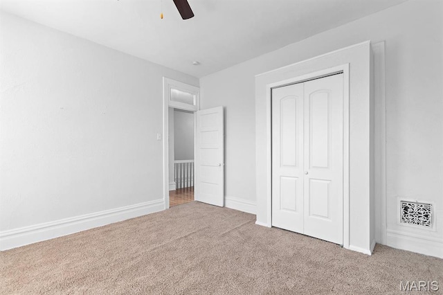 3921 Shenandoah Ave, Saint Louis, MO 63110 - unfurnished bedroom with carpet, a closet, a ceiling fan, and baseboards