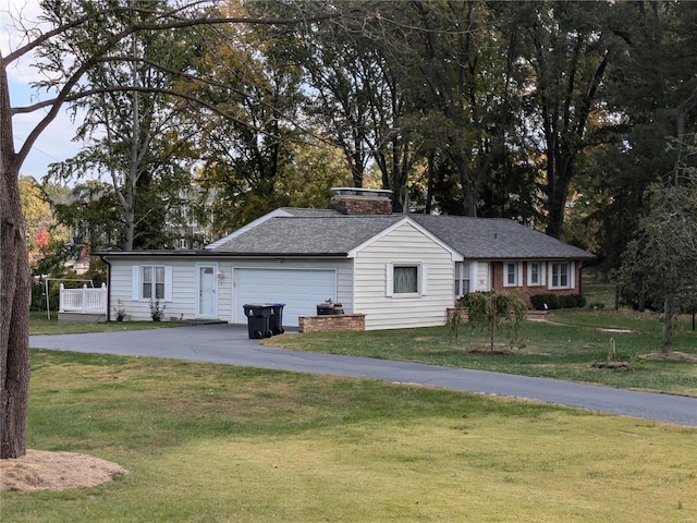 7 Carole Ln, Frontenac, MO 63131 - view of front of house with asphalt driveway, a front lawn, an attached garage, and a chimney