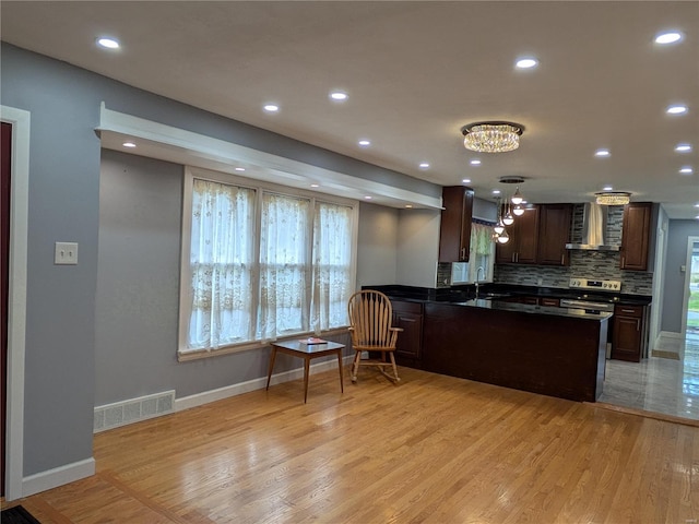 7 Carole Ln, Frontenac, MO 63131 - kitchen featuring wall chimney exhaust hood, dark countertops, a chandelier, a sink, and baseboards