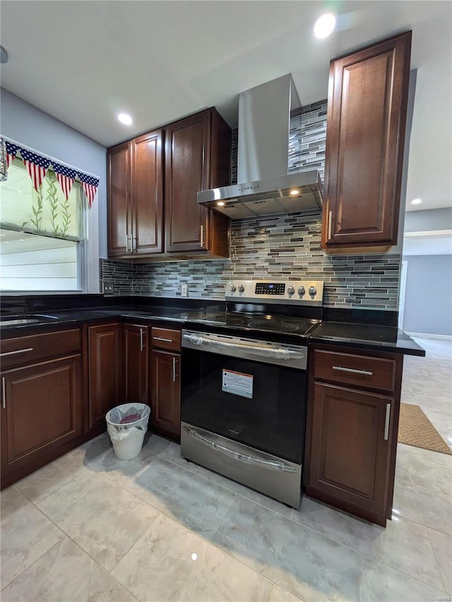 7 Carole Ln, Frontenac, MO 63131 - kitchen with stainless steel range with electric stovetop, wall chimney range hood, dark countertops, backsplash, and recessed lighting