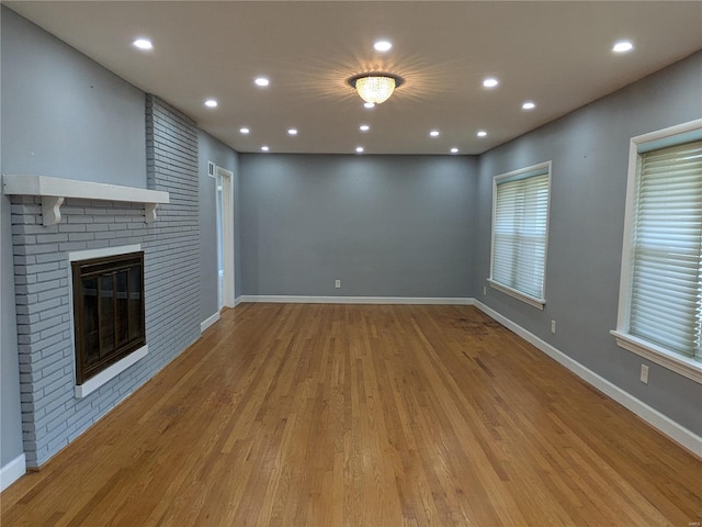7 Carole Ln, Frontenac, MO 63131 - unfurnished living room featuring wood finished floors, recessed lighting, baseboards, and a brick fireplace