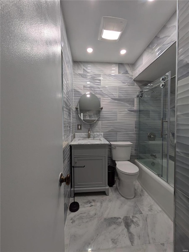 7 Carole Ln, Frontenac, MO 63131 - full bathroom featuring marble finish flooring, shower / bath combination with glass door, toilet, vanity, and recessed lighting
