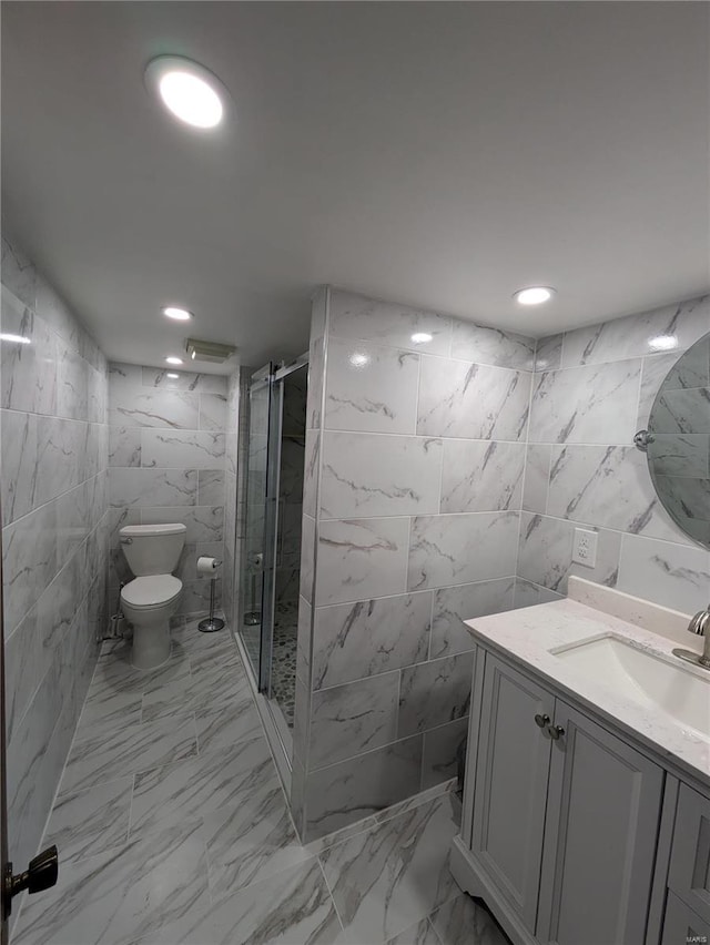 7 Carole Ln, Frontenac, MO 63131 - bathroom with tile walls, a shower stall, vanity, toilet, and marble look tile flooring