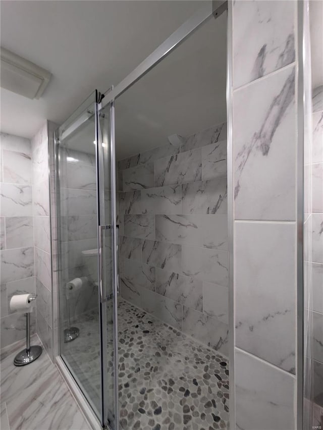 7 Carole Ln, Frontenac, MO 63131 - bathroom featuring a stall shower and marble finish flooring
