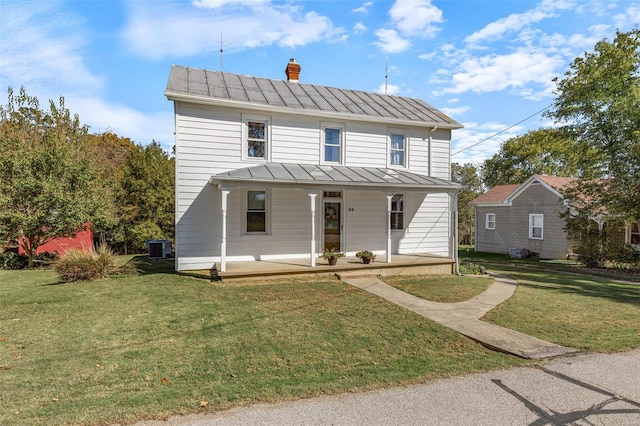 94 Jersey Ln, Bloomsdale, MO 63627 - view of front of home featuring a standing seam roof, metal roof, covered porch, and a front lawn