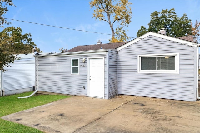 9608 Flora Ave, Saint Louis, MO 63114 - back of property with a patio area and a chimney