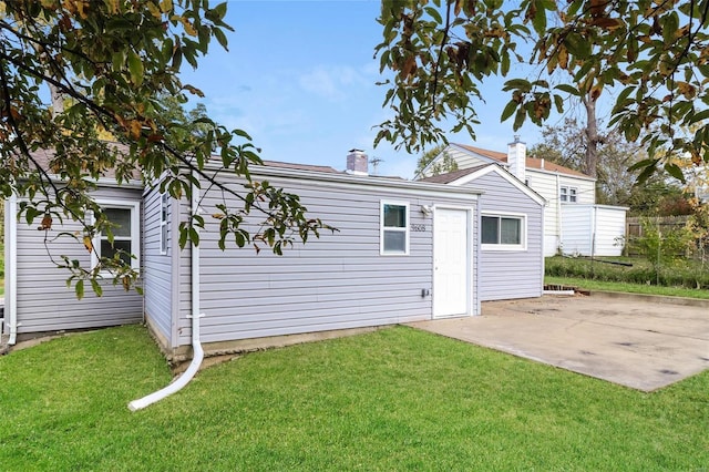 9608 Flora Ave, Saint Louis, MO 63114 - rear view of property with a patio, a yard, and a chimney