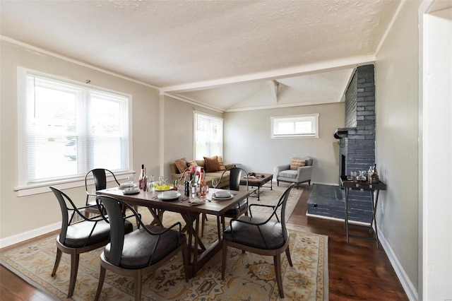 9608 Flora Ave, Saint Louis, MO 63114 - dining space with dark wood finished floors, a textured ceiling, and baseboards