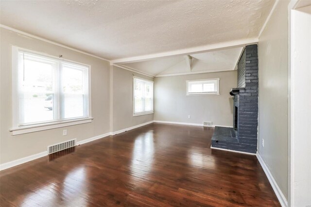 9608 Flora Ave, Saint Louis, MO 63114 - unfurnished living room featuring wood finished floors, a brick fireplace, a textured ceiling, and baseboards
