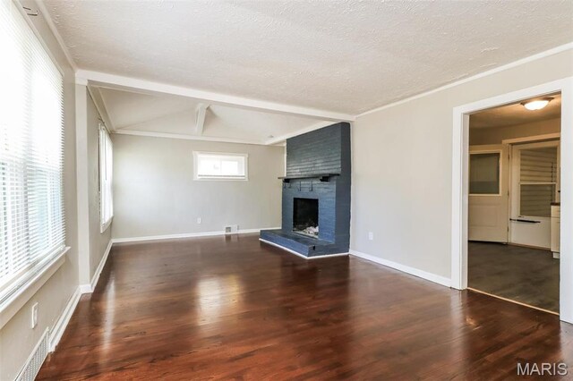 9608 Flora Ave, Saint Louis, MO 63114 - unfurnished living room featuring a fireplace, wood finished floors, baseboards, and a textured ceiling