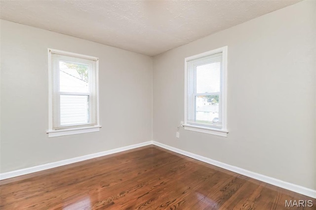 9608 Flora Ave, Saint Louis, MO 63114 - unfurnished room featuring dark wood-style floors and baseboards