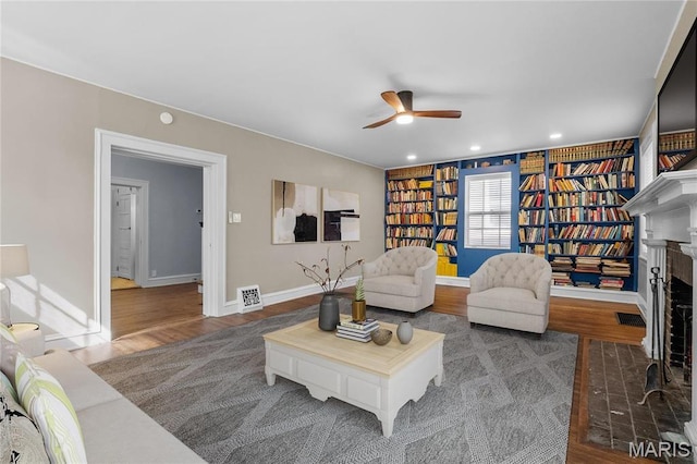 5099 Waterman Blvd, Saint Louis, MO 63108 - living area with ceiling fan, wood finished floors, baseboards, a brick fireplace, and recessed lighting