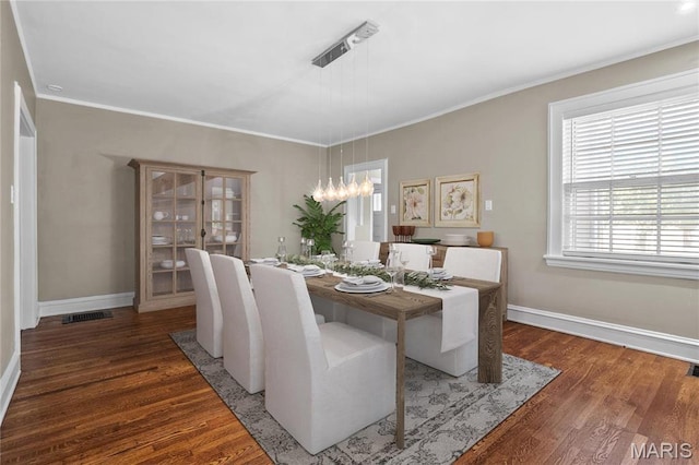 5099 Waterman Blvd, Saint Louis, MO 63108 - dining space featuring wood finished floors, baseboards, a chandelier, and crown molding