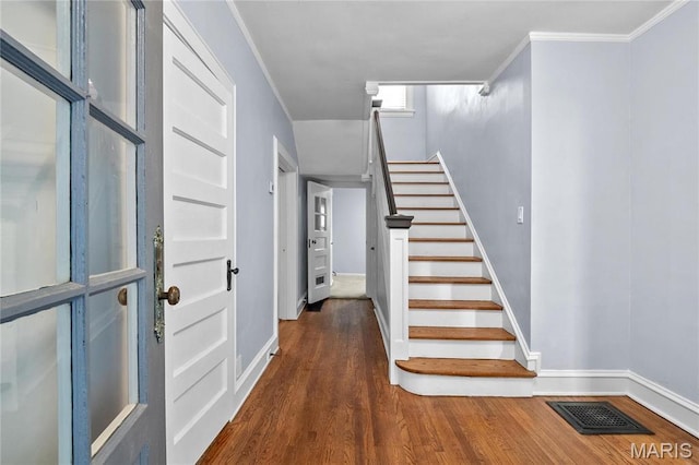5099 Waterman Blvd, Saint Louis, MO 63108 - foyer entrance with wood finished floors, baseboards, stairs, and ornamental molding