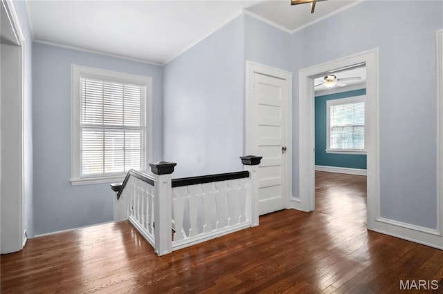 5099 Waterman Blvd, Saint Louis, MO 63108 - hallway with ornamental molding, wood finished floors, baseboards, and an upstairs landing