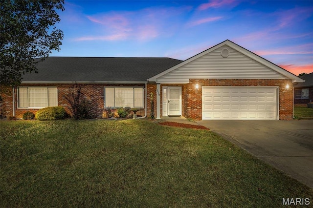 119 Ohio Ct, Farmington, MO 63640 - ranch-style home with concrete driveway, brick siding, a garage, and a yard